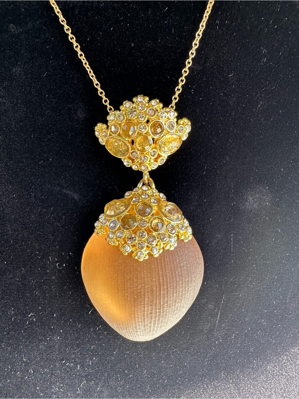 Alexis Bittar gold tone necklace with gold pendent.